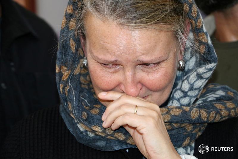 Lise Grande, UN humanitarian coordinator in Yemen, reacts as she visits children injured in last week's air strike that killed dozens at a hospital in Saada