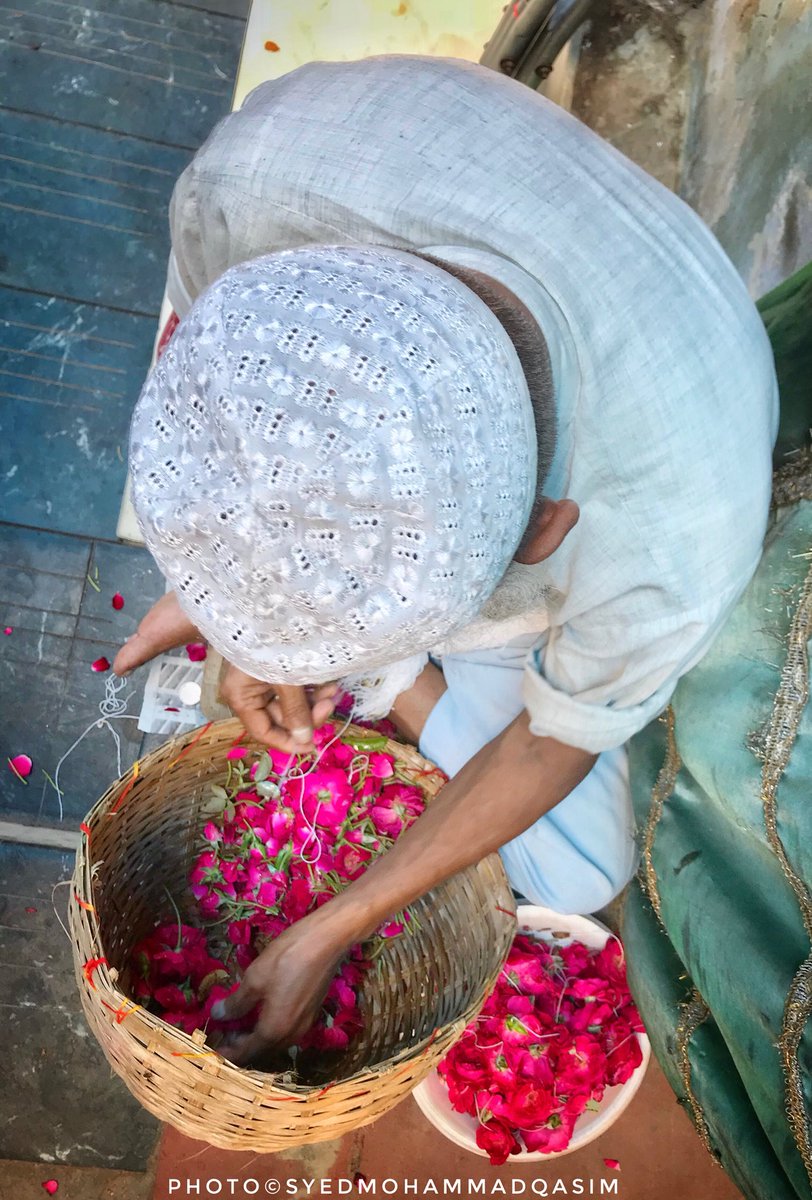 Cease looking for flowers! 
There blooms a garden in your own home
While you look for trinkets
The treasure house awaits you in your own being
-Rumi
A man busy making a garland of roses which will soon be offered at the shrine of Delhi’s most celebrated Sufi Hz NizamuddinAulia RA