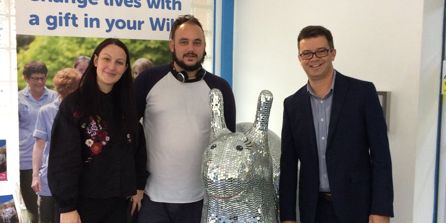 photo of three people with a silver snail