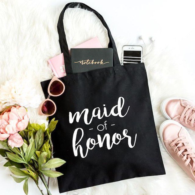 shopsaltvine's tweet photo. Looking for the perfect gift for your Maid of Honor?  Check out our wedding collection for tees, tanks, mugs, and this adorable tote to carry all her wedding day essentials!  #maidofhonor #maidofhonorgift #bridesmaid #bridesquad #bacheloretteparty #weddingday #moh #engaged #… https://t.co/GVnBJ3dfPF