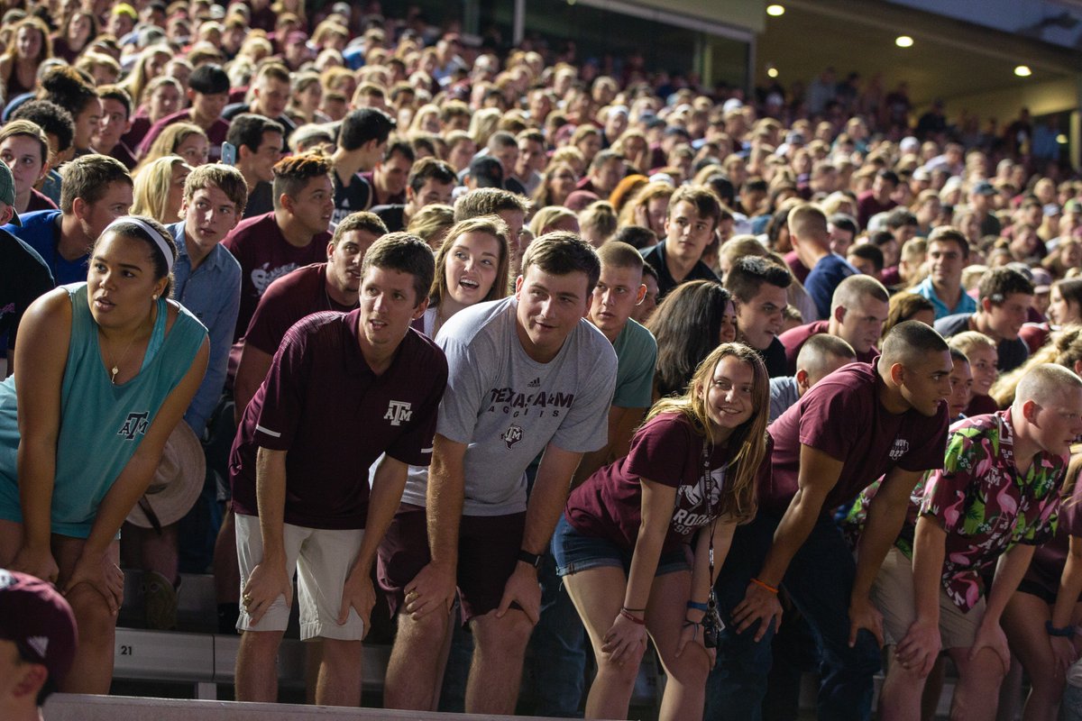 Aggies humped over doing a yell