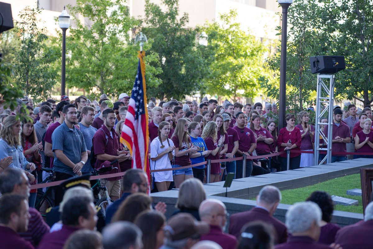 A crowd of people around the Reveille graves