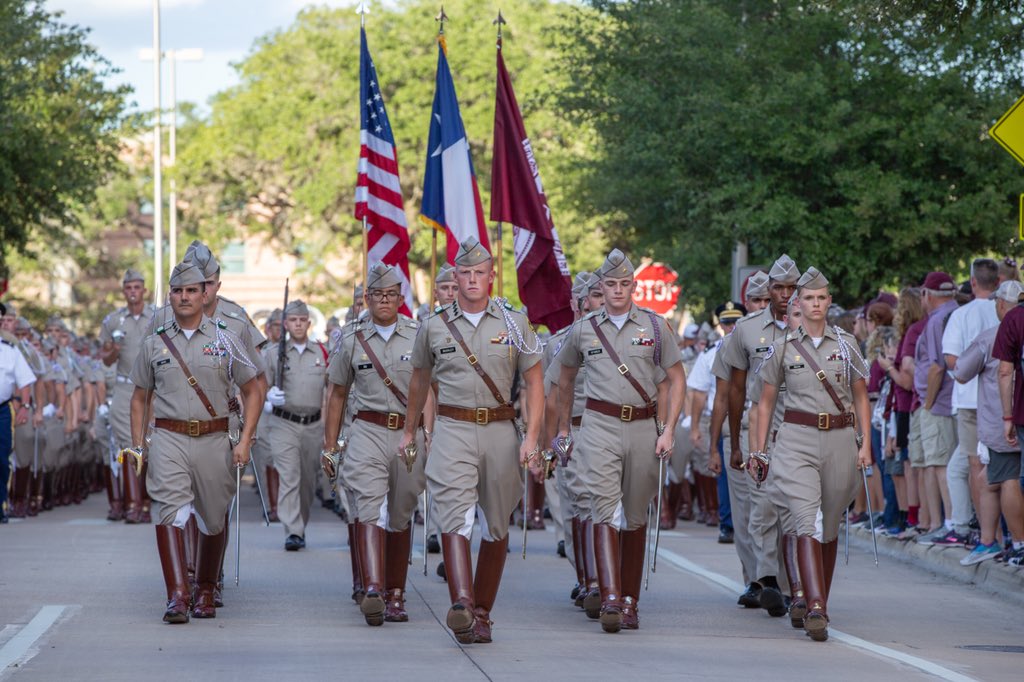 Corps marching toward camera in the middle of campus