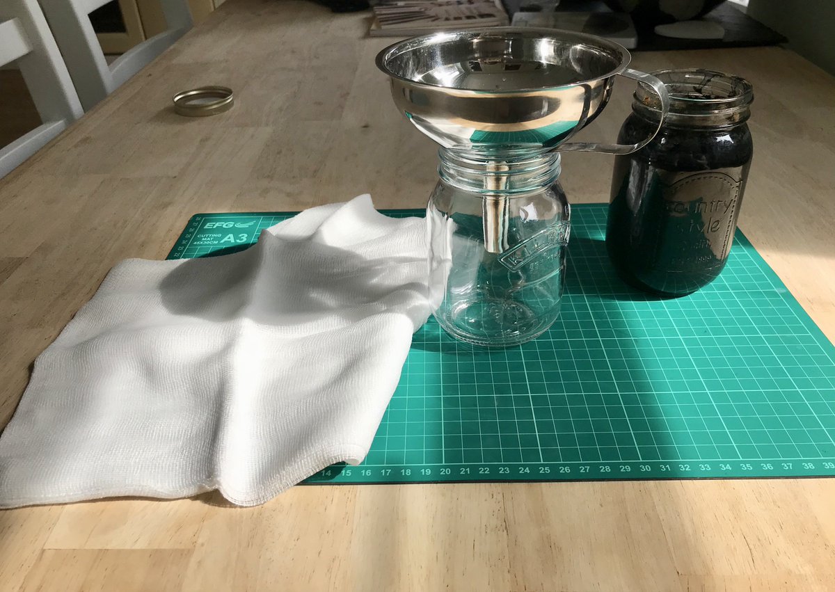 18. Last stage! (Thanks for sticking with me) I strained the mixture through a muslin cloth using a funnel. More sensible people would probably use gloves for this part. I left it for a while to let gravity do its thing. Chloe stealthily checked my progress.