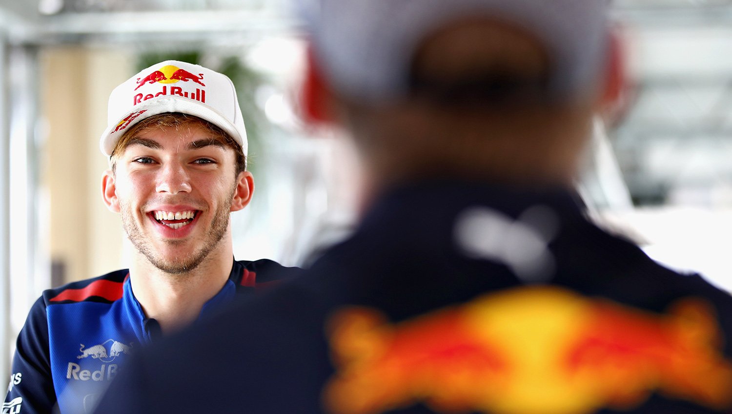 A smiling Pierre Gasly sits with Max Verstappen