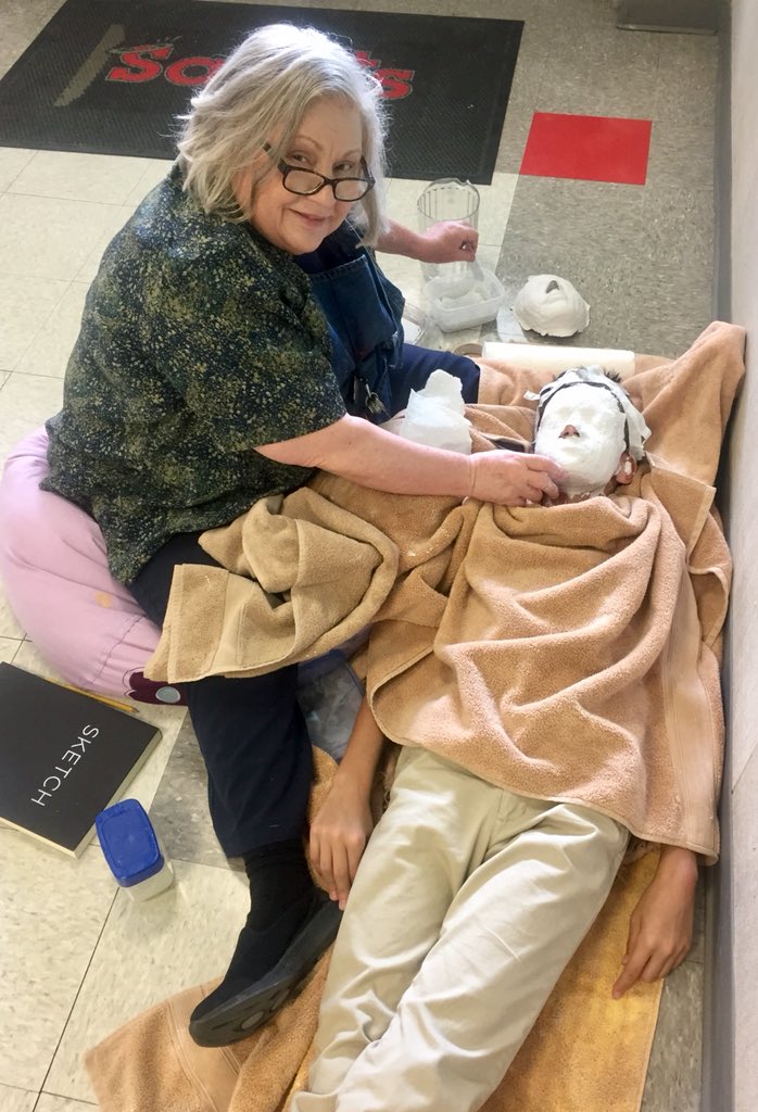 SymondsHSES's tweet photo. Mrs. Day works and a 7th grade student to create an “alive” mask.  Students will use these masks to represent themselves as a pharaoh on a relief canvas as part of their Out of Egypt unit.  @hsessaints #WeAreHSES18 https://t.co/ek2yLwCHB7