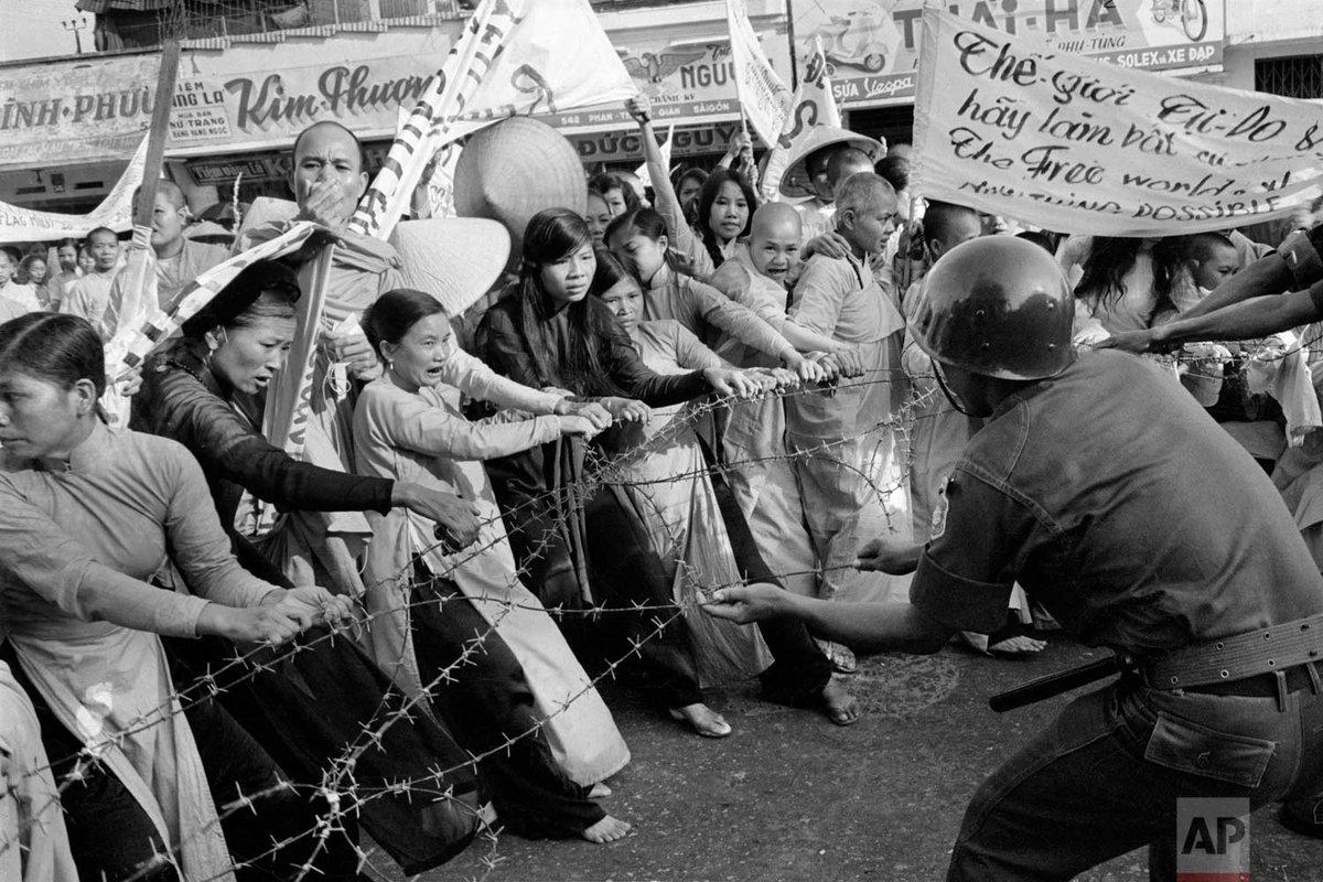 AP_Images's tweet photo. #OTD in 1963, martial law was declared in South Vietnam as police and army troops began a violent crackdown on Buddhist anti-government protesters. Photo shows Buddhist monks and women in front of the Giac Minh pagoda in Saigon on July 17, 1963. | Photo Horst Faas https://t.co/pOSKMi6mjZ