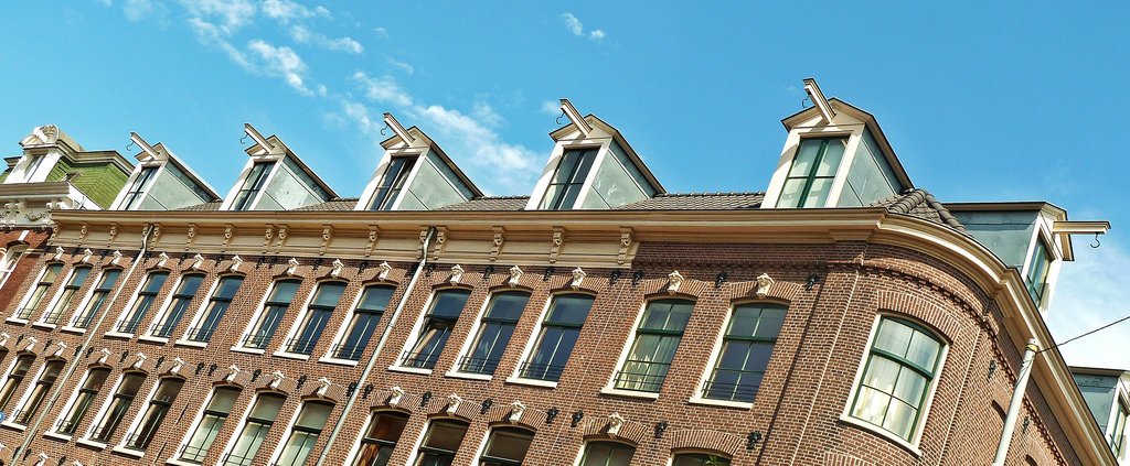 Here is a row of these "Hijsbalken" (hoisting beams), very plain ones, in Amsterdam. Each house had their own.