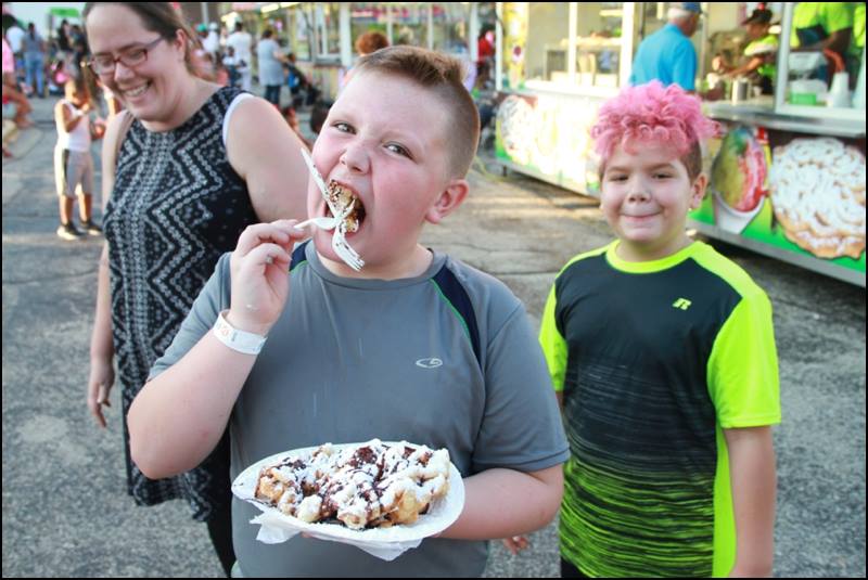 There's only one proper way to eat a funnel cake..the messier the better! 📸: Kenneth Hansboro