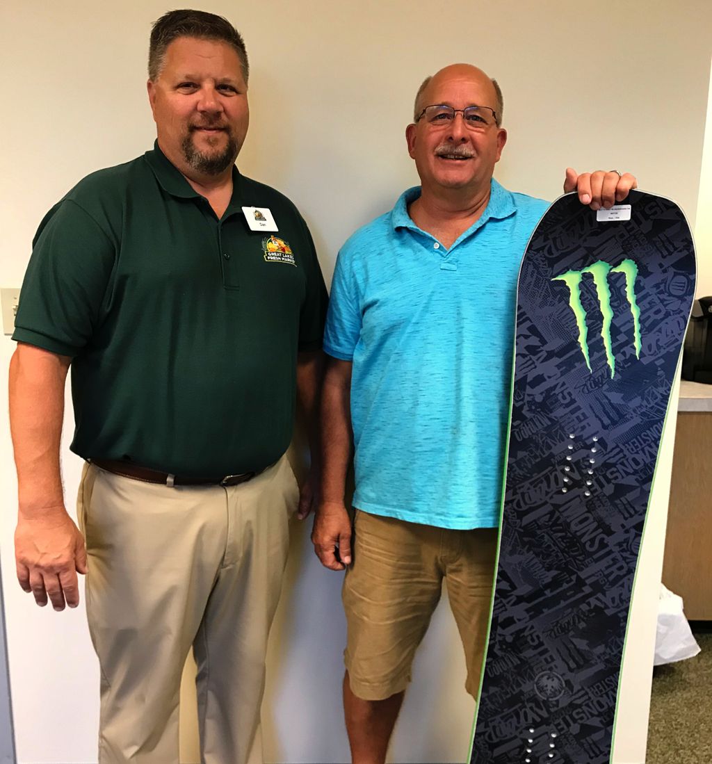 GLFreshMarket's tweet photo. He might be wearing shorts now but in a few short months Greg will be riding this awesome Monster Energy/Never Summer Industries snow board!  Congratulations and thank you for hanging out with us at the 2018 Moose Fest! https://t.co/if8W2bO16Z