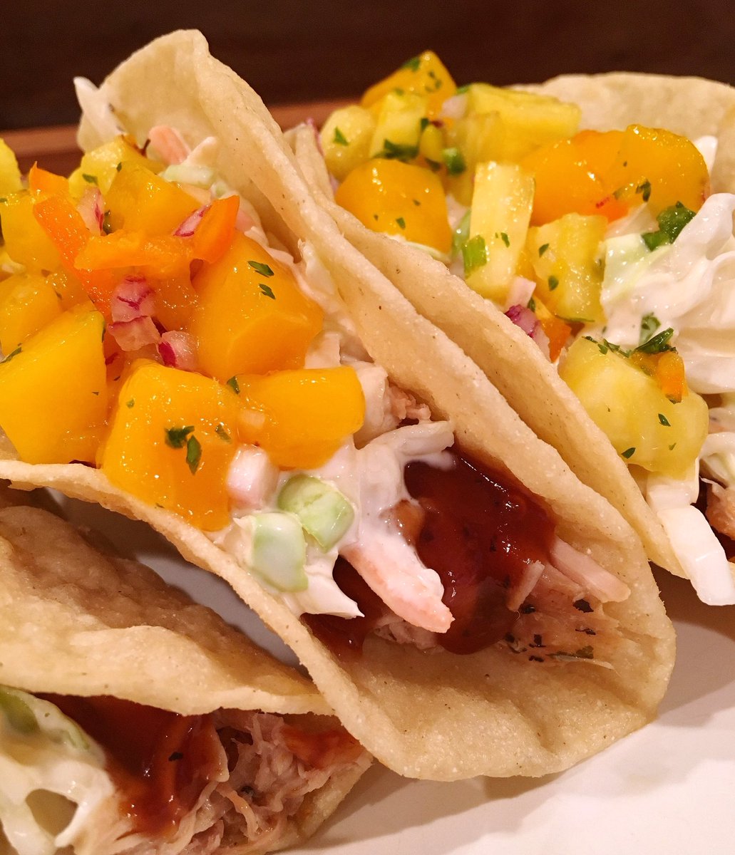 Island Tacos with pulled pork drizzled with BBQ sauce, creamy coleslaw, and pineapple mango salsa! norinesnest.com/island-tacos/