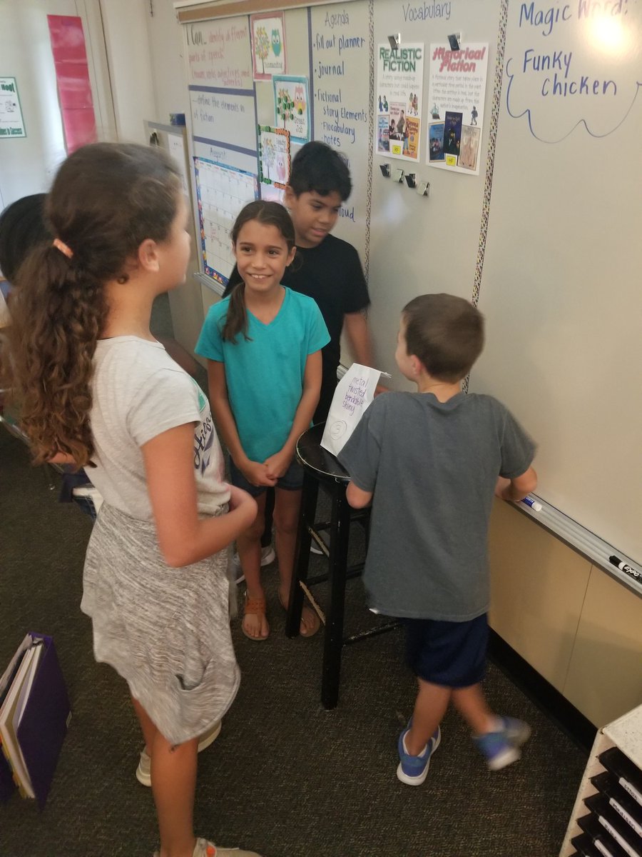 4th graders collaborating to review adjectives using mystery bag activity. <a href="/HumbleISD_OE/">Oaks Elementary</a>