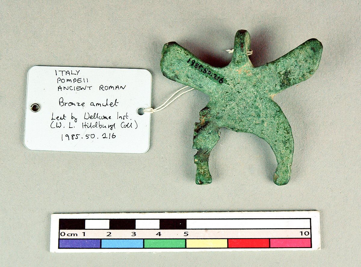 Pitt_Rivers's tweet photo. Mount Vesuvius is thought to have erupted #onthisday in AD 79. This is a #Roman bronze amulet from #Pompeii, possibly comprising a manu fica or ‘fig sign’ - a mildly obscene gesture to ward off evil. https://t.co/qI5d2aUgiD