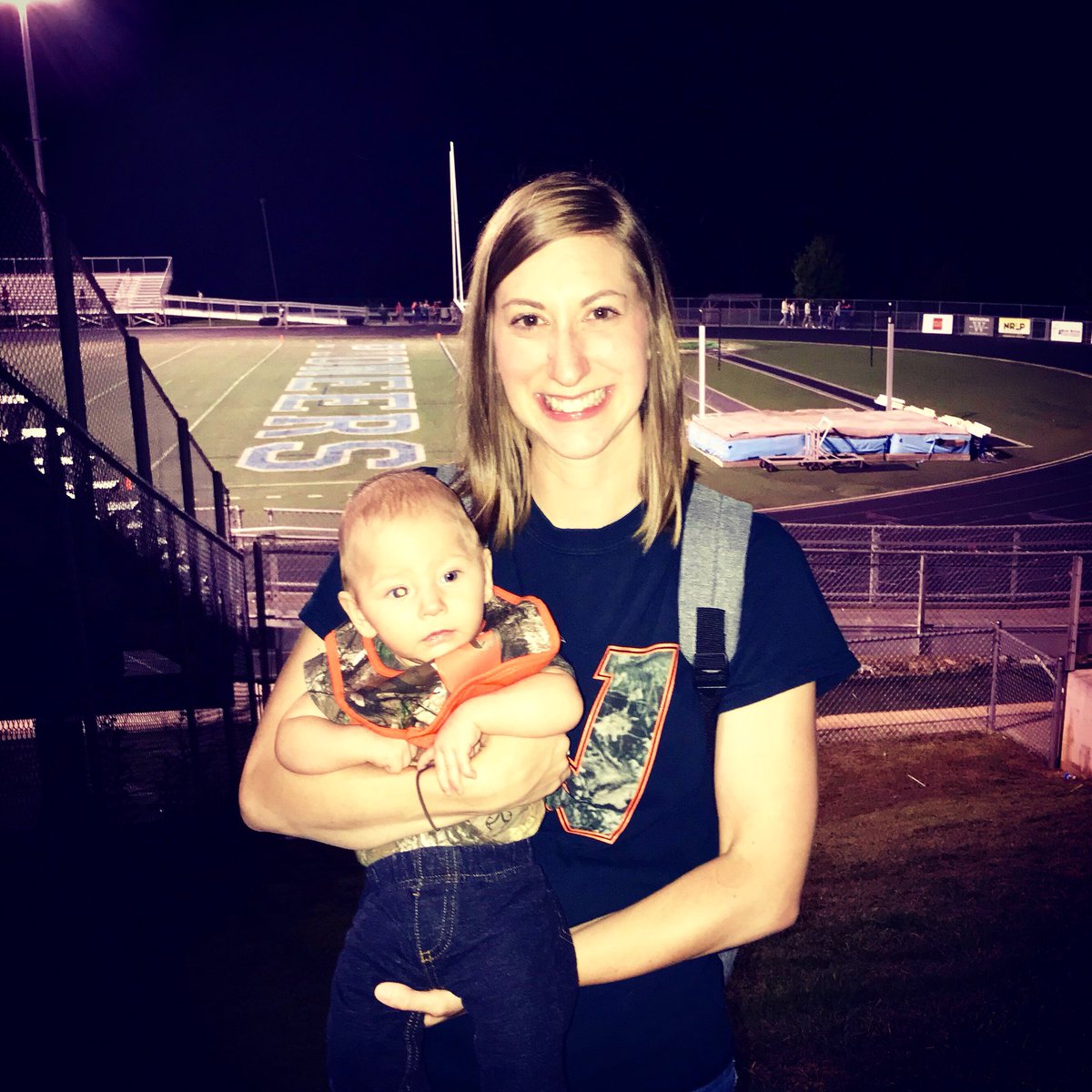 mrsmarkland's tweet photo. My freshman year of high school I took my Healthful Living project Baby Think-it-Over “Baby Buster” to the @WHSPioneerPride-Avery game in a camo onesie.  Tonight, I took my son in his camo onesie to the final battle for the golden bucket. #gopioneers #endofanera https://t.co/OyRin7Tw83