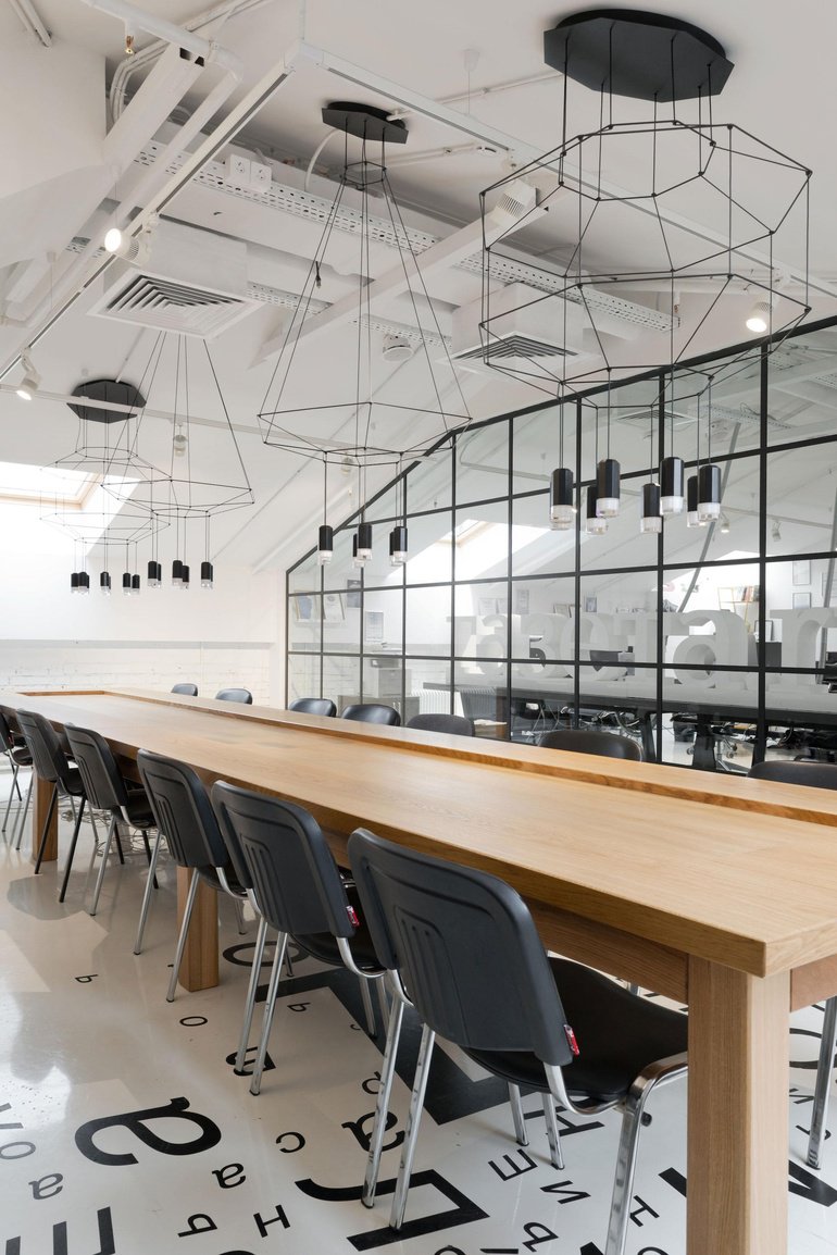 Design_4_Home's tweet image. Black letters, scattered across the floor, reference newspaper type at a new agency&apos;s Moscow office