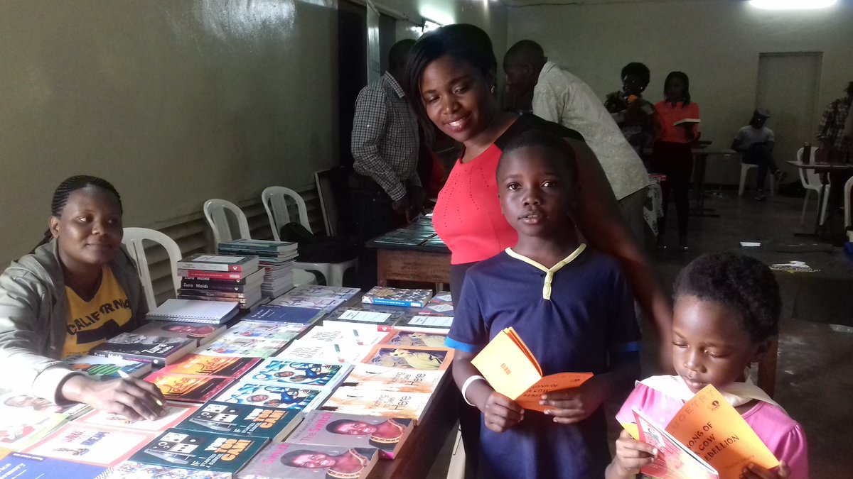 Hailey and Israel with their harvest from the #UgandaBookMarket @ugwomenwriters @SusanMuyiyi