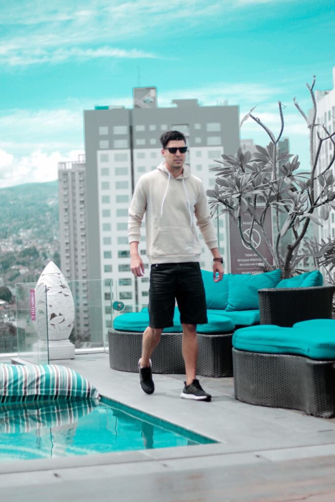 Alan wearing beige pullover hoodie