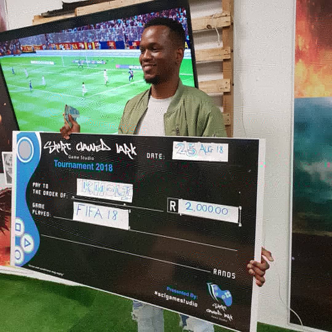 SCLGameStudio's tweet photo. Congratulations Kholi our 2nd FIFA Tournament Winner. He was the last person to register, came in just as we were closing registrations yesterday. LOOK AT GOD! Congratulations. He walks away with R2,000.00 in his pocket. #saturdayfun #sclgamestudio #Bloemfontein #lemomall https://t.co/3aWCEOTQAl