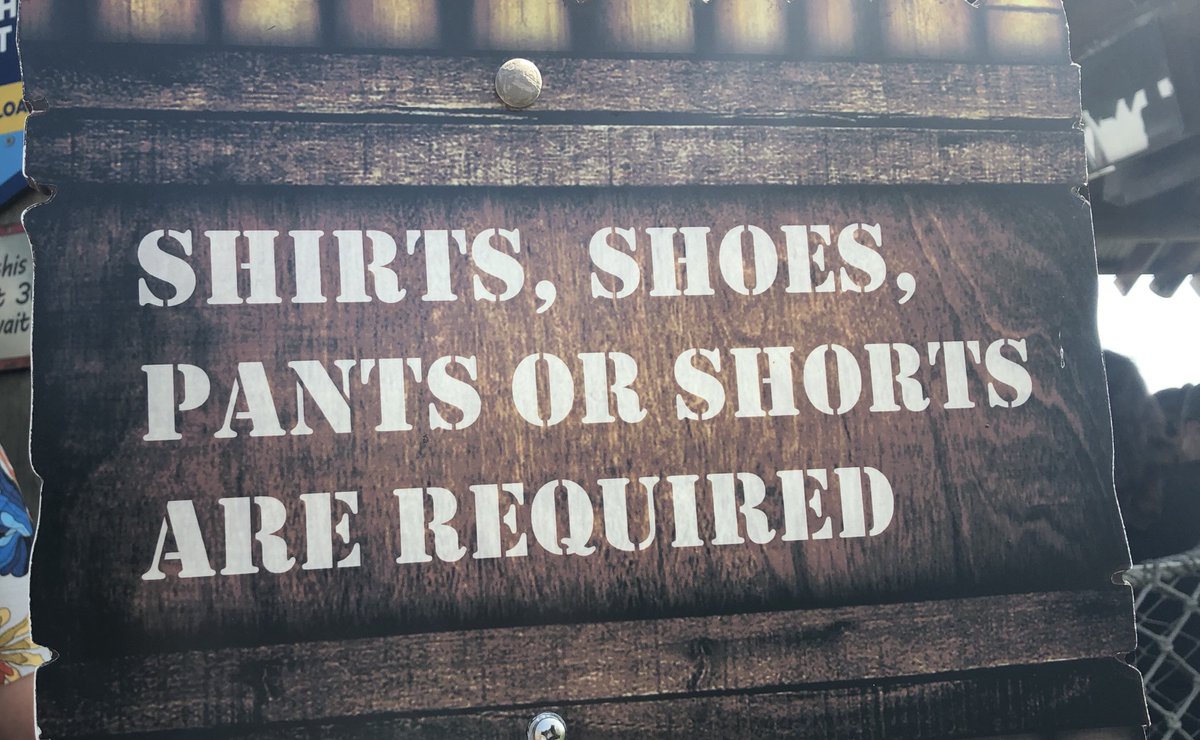 A sign that says, "shirt, shoes, pants, or shorts required"