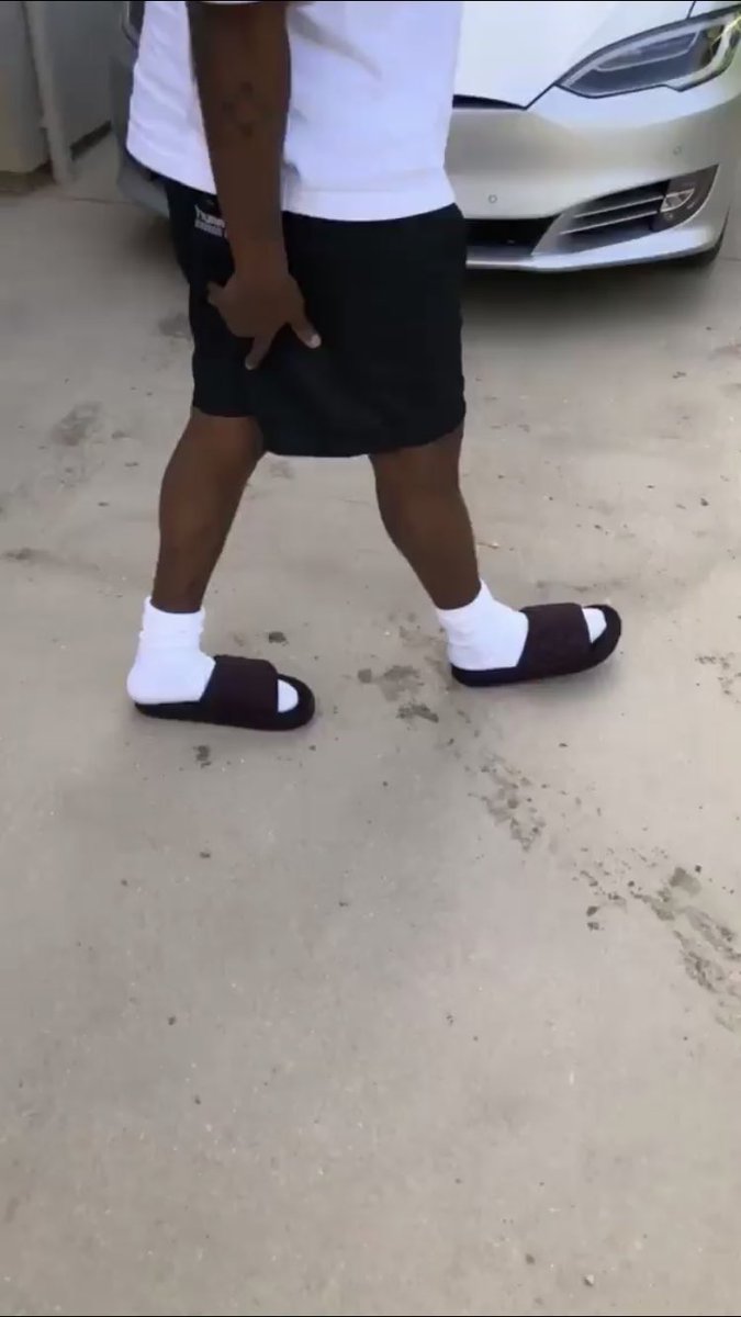 kanye wearing yeezy slides