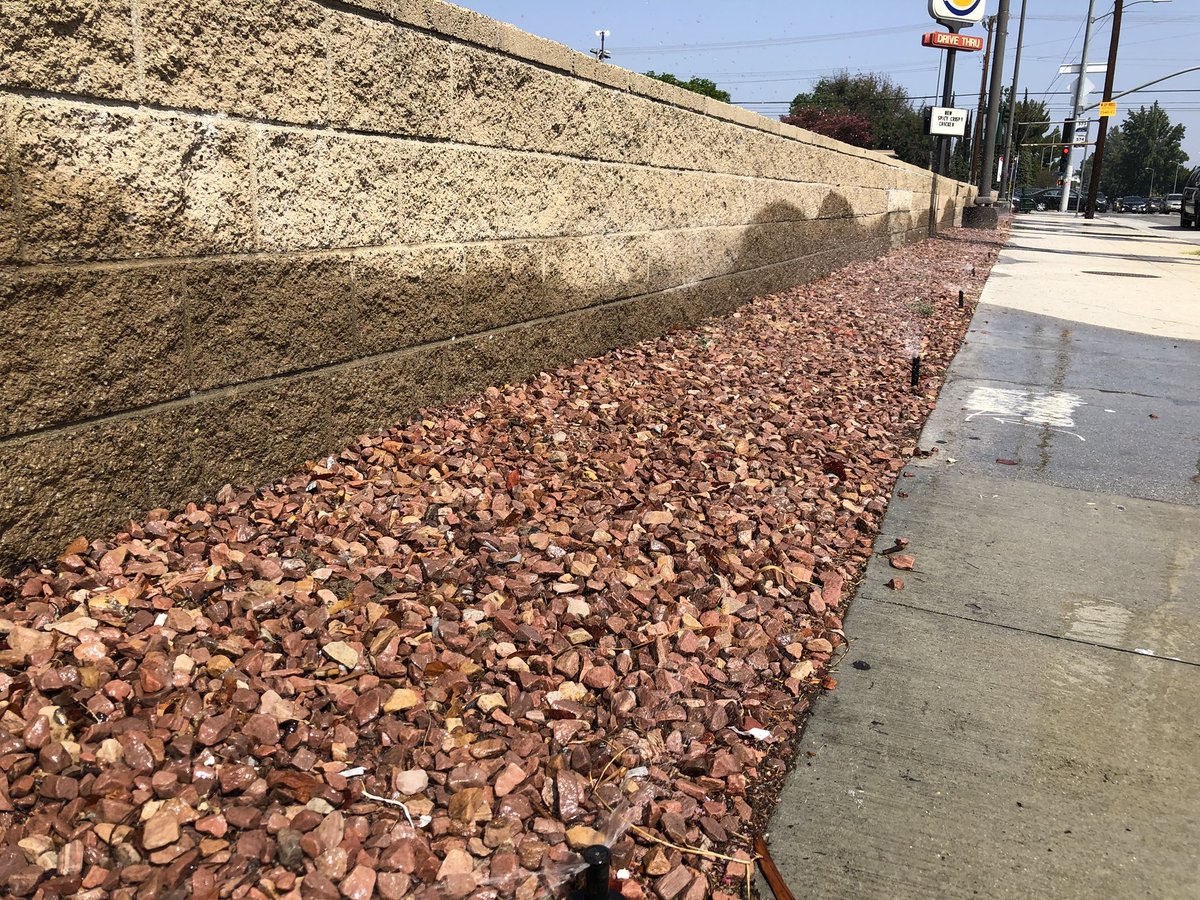 JoshMark's tweet photo. Sprinklers in front of @Target and @BurgerKing in Northridge, CA have been watering rocks for over an hour.  Rocks do not need to be watered. No one knows how to fix it. #drought #water #wastingwater @LADWP https://t.co/SYyQUB5fF1