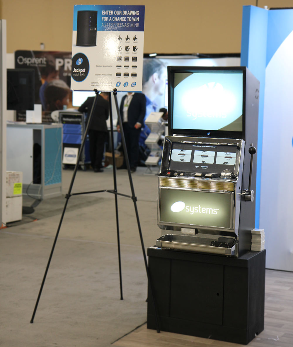 iXsystems's tweet photo. Have you tried your luck on our slot machine yet? Come by #iXsystems booth #2224 and play to win! Also, pick up some schwag and the new #iXMag while you’re there! @VMworld #OpenSource #VMworld #FreeNAS #TrueNAS #Storage #Server #iXMagV2 https://t.co/E8bsgxPv5F