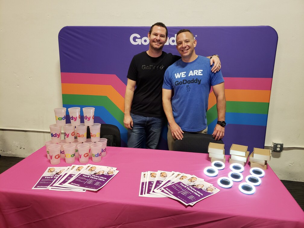 GoDaddyLife's tweet photo. Weโre at the Phoenix Pride Job Fair (until 2pm) waiting to meet you! Stop by our booth and cash in on this opportunity to meet with local LGBTQ+ supportive organizations! #GDUNITED ๐ https://t.co/TSAgkSt49E https://t.co/1rCl9UYiOK