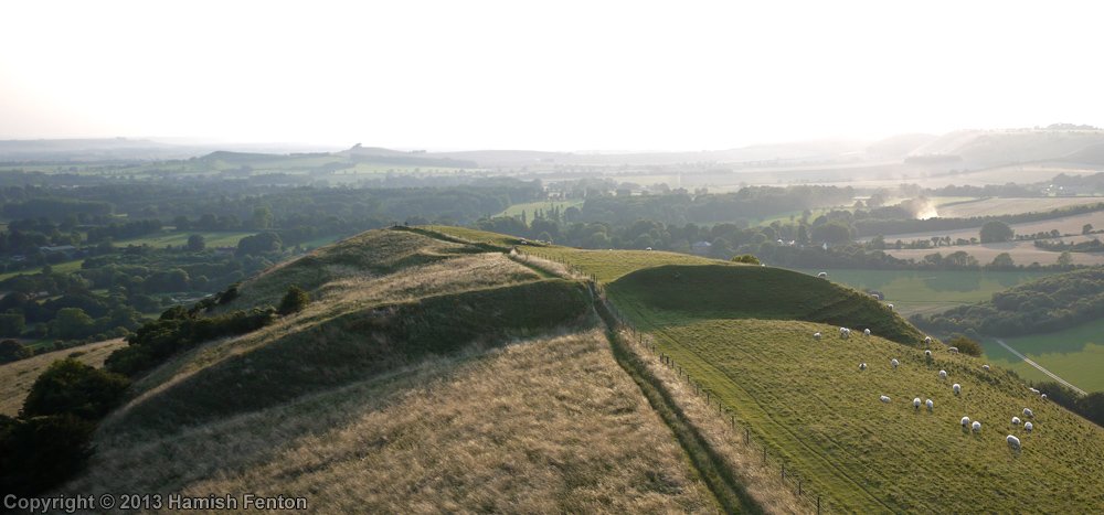 It’s been a while since we’ve seen one of #HamishFenton’s excellent kite photos so here’s one of his, taken in 2013, of #GiantsGrave, a promontory fort defining the summit of #MartinshellHill, looking west down across the #ValeofPewsey in #Wiltshire #HillfortsWednesday - lovely