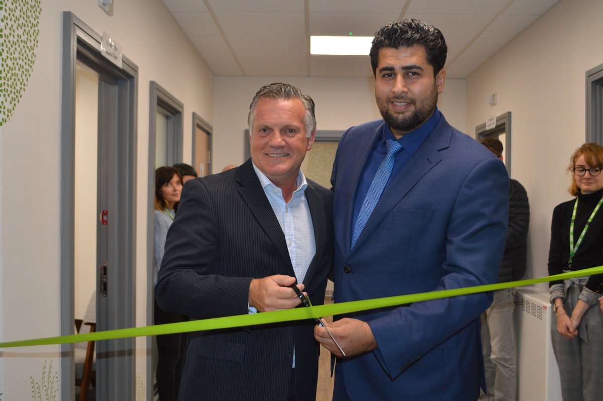 QPR's Andy Sinton cutting the ribbon with Shahin Sadafi, Chair of Grenfell  United