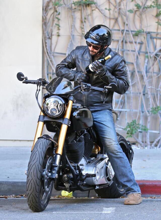 keanuthings's tweet image. keanu reeves shoving a bottle of wine into his jacket and riding off on his motorcycle