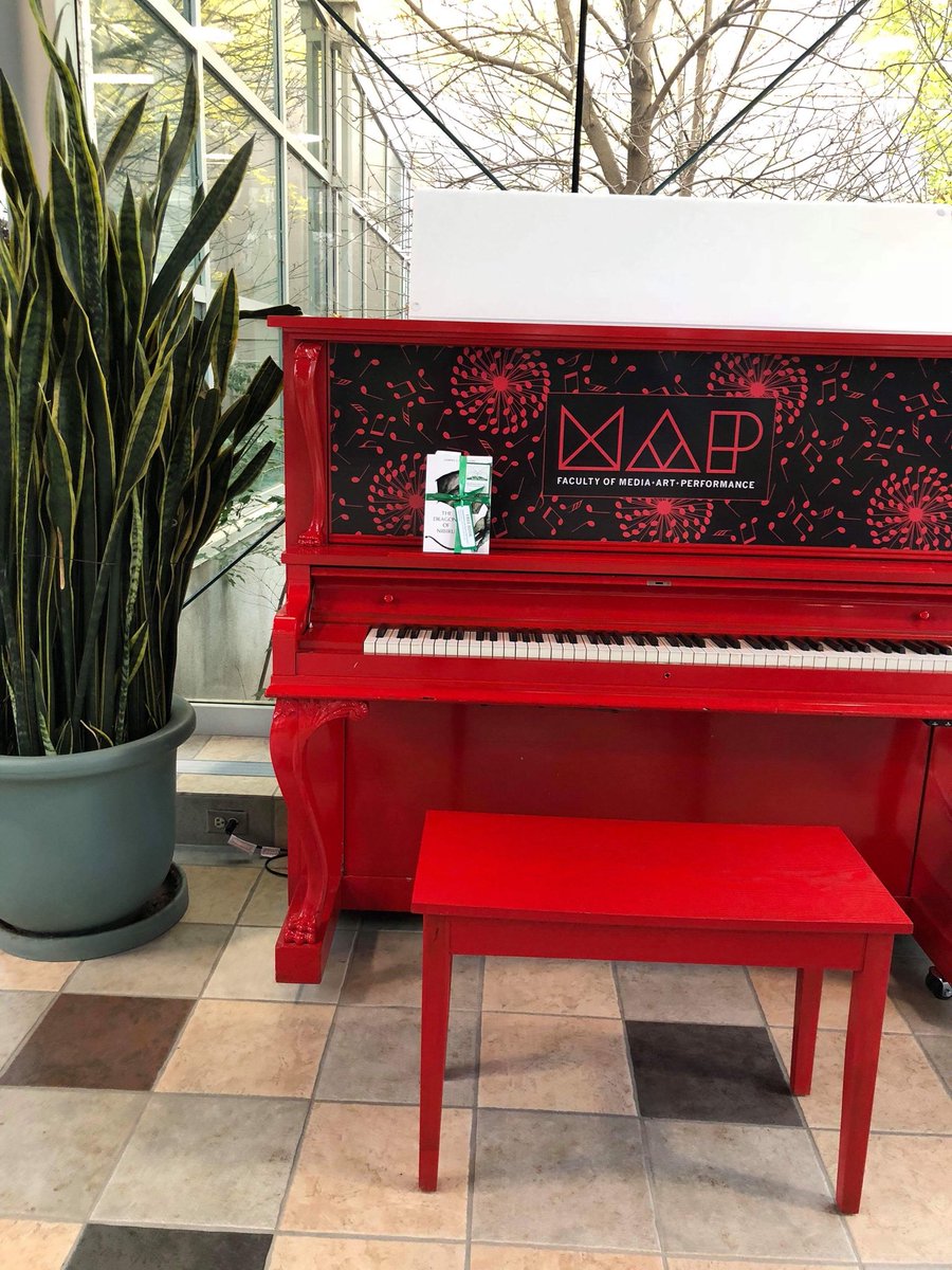 bookfairiessask's tweet photo. Look how red this Public Piano is at the University of Regina 🎹 Mini book fairy Zoe is helping us hide a signed copy of Lorna J. Carleton’s The Dragons of Nibiru 🐉 Hurry down to the public piano to get your signed copy of the book. #TheDragonsOfNibiru #ibelieveinbookfairies https://t.co/1OemjFMKNS