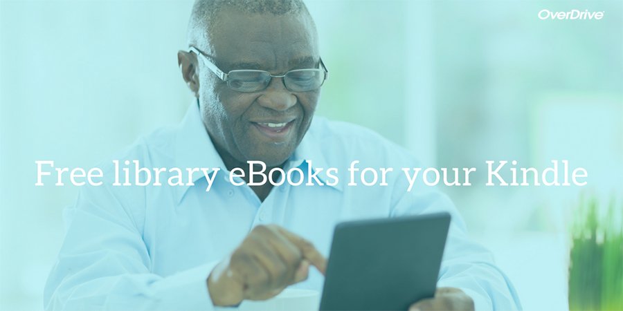 a Black man smiling as he reads his eBook on his tablet