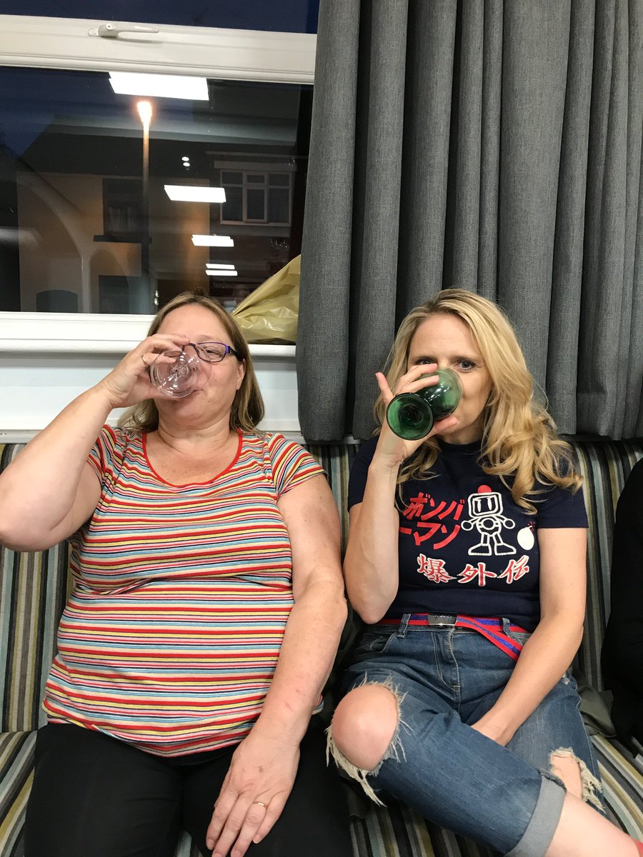 Last night's meeting was wine tasting- below are two of our members showing how it's done!