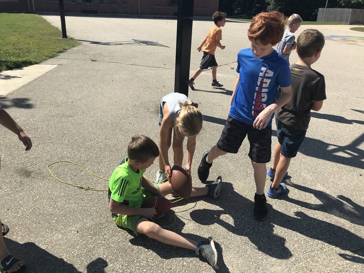 Maddockteach's tweet image. Spontaneous physics and engineering learning on the playground today: how to get that stuck ball unstuck? Throwing things at it? Ropes? Throwing things attached to ropes? #miniscientists #playgroundscience