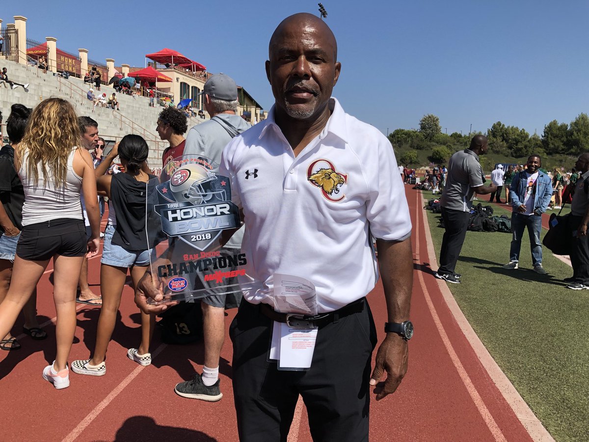 honorgroup's tweet photo. @OaksChrstnLions head coach and former NFL Coach, Charles Collins @CoachC_C sporting the 2018 #honorbowl Championship trophy. His coaching staff includes former NFL athletes @EricDickerson and #gregtownsend #giveback #educate #empower #equip #4thevets https://t.co/M8N8uImqIR