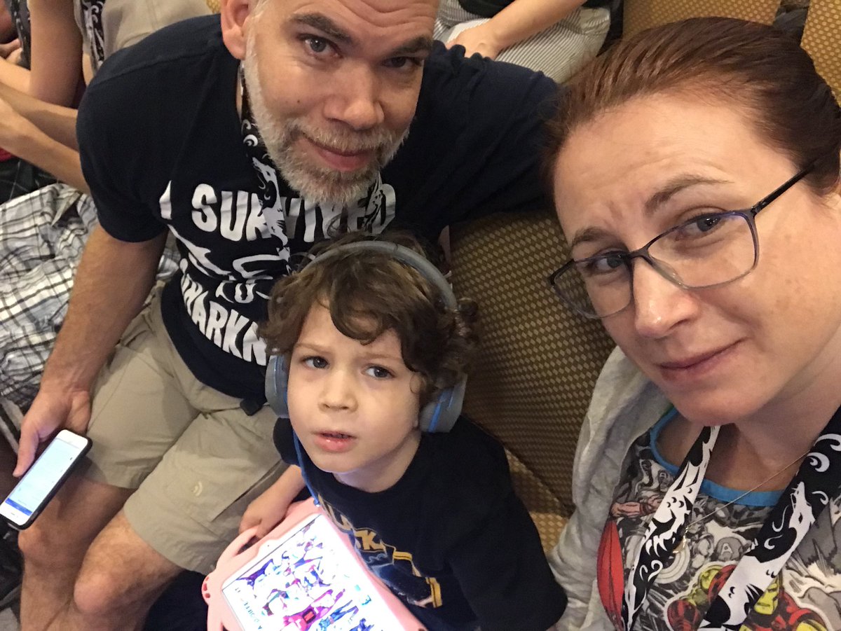 Starre's tweet image. In Robot Battles early for good seats. One of us is unhappy we asked him to look up from his iPad. But soon he’ll be focused on the stage and talking about the robots he wants to build. 
#DragonCon2018 #robotbattles #STEMkid