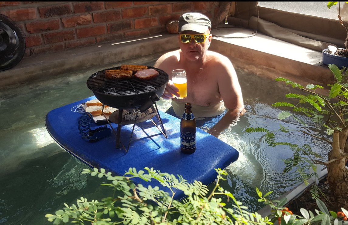 MusicAndWineSa's tweet photo. @TOPSatSPAR #TopsBeerChallenge I challenge you to drink beer in a fun way. My beer and small weber with meat on the coals floating on boogie board in my pool https://t.co/EgCk17BCpY