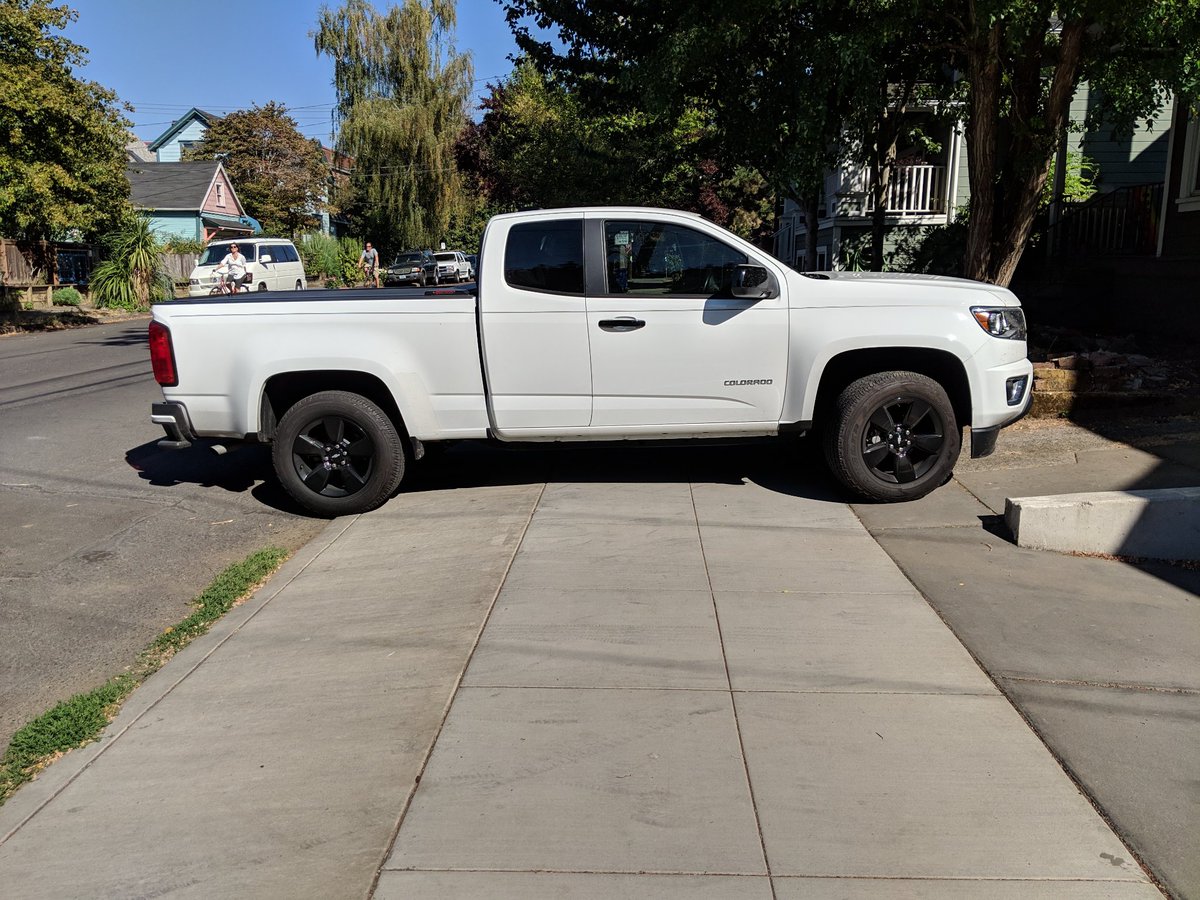 A truck blocking the sidewalk.