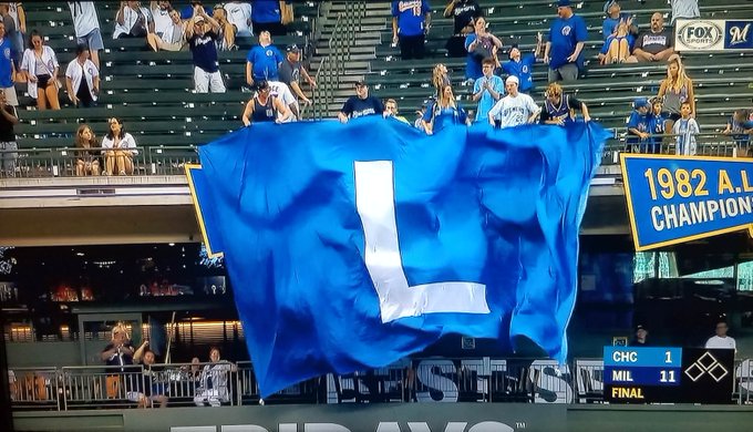 Some Brewers fans fly a "L" flag after Milwaukee defeats the Chicago Cubs