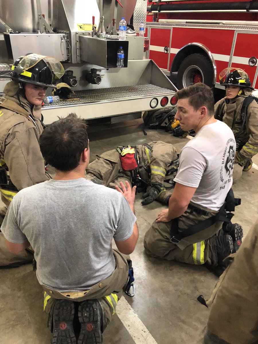 ToulonFire's tweet photo. Training night - TFD’s newest SCHS cadet recruits Chris Roark and Donovan Ford getting instruction from Asst. Chief Joey Rediger and Training Officer Chase Wallace on rescuing a downed firefighter. #RollSC https://t.co/87Y3SXxt7K