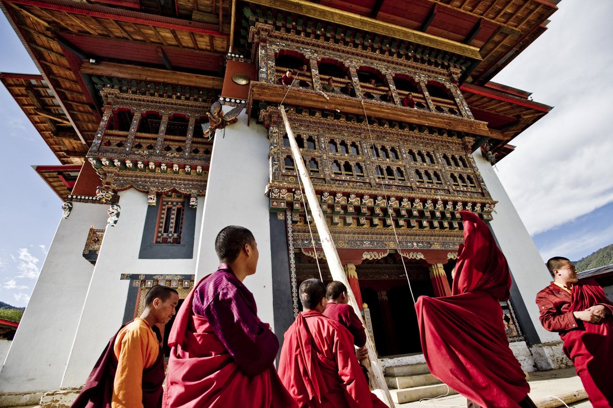 Monks carrying out maintenance work at Gangtey Goempa Monastery, Bhutan. The monastery is in the Phobjikha Valley where the black-necked cranes visit Bhutan to roost, circling the monastery three times on arrival and repeating this circling when returning to Tibet. #Bhutan #Asia