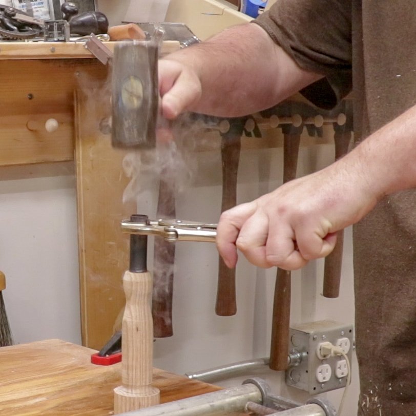 AUSTINJONES30's tweet image. Hammering a hot copper pipe over a handle socket to make a ferrule. When the pipe cools it shrinks tight over the wood. Then I&apos;ll trim it flush.

#handlemaking #lathe