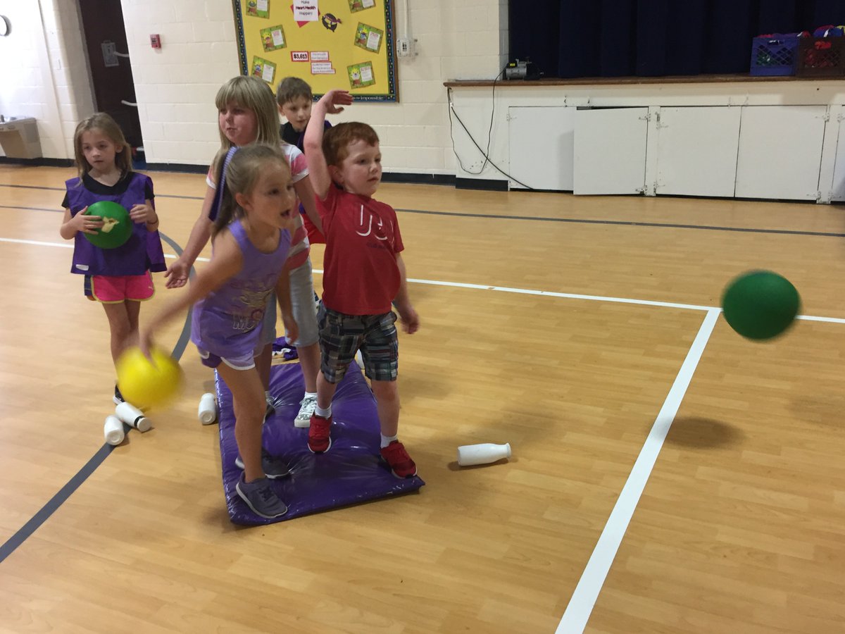 First grade Ss working on underhand toss and roll while playing Battle Ship. #ATribeBegins