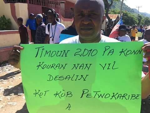HaitiInfoProj's tweet photo. #PetroCaribeCorruption protests in Vil Desalin, the first capital of #Haiti. No slick banners, posters &amp; t-shirts here! Just the people with their own cardboard, colored paper and pens! One reads "Since 2010 the kids of Vil Desalin haven't had electricity. Where's the money?" https://t.co/cIlmSAP0sq