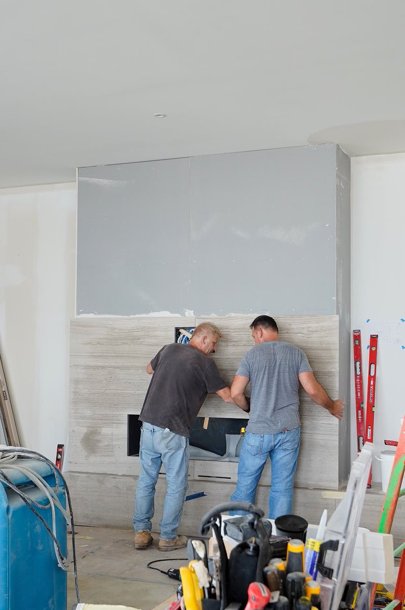 Last week we had a chance to pop in and check out #whatsGoingOnAtWalton

We caught up with Marek and Mickey installing Roman #travertine over the to-be fireplace in one of the units at #9westwalton