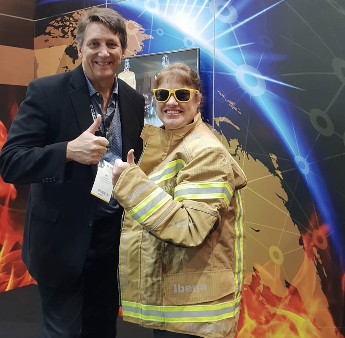 USCSAustralia's tweet photo. Commercial Specialist Donna Carter rocking flamin' great fabric from U.S. manufacturer PBI Performance Products on show at #afac2018. #USwithAUS https://t.co/NQLNo9YlnH