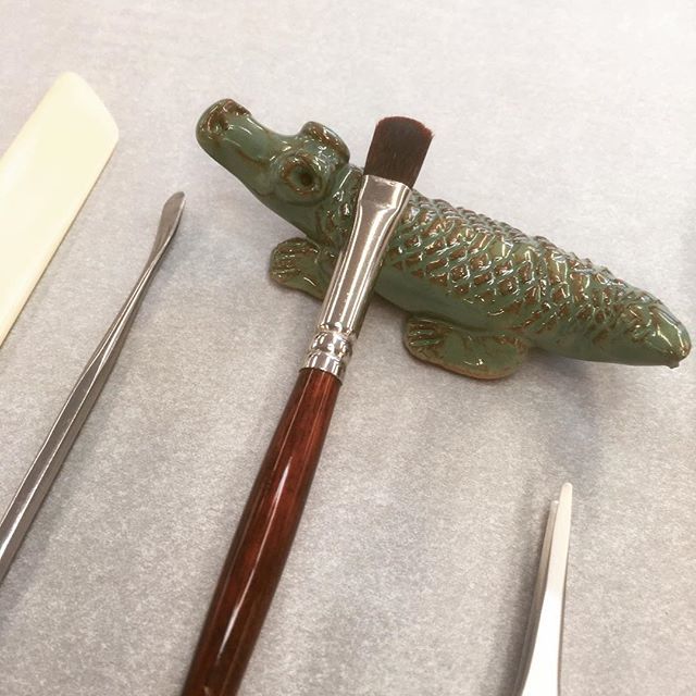 BodCons's tweet photo. Animal of the week! This cheery and chunky crocodile is new in the studio and doing a fine job of holding a paste brush. What brush holders do you have on your bench? #brushholder #conservationtools #todayinthestudio #donotpet https://t.co/rIvz6Qe83d https://t.co/mHR99Dr6UJ