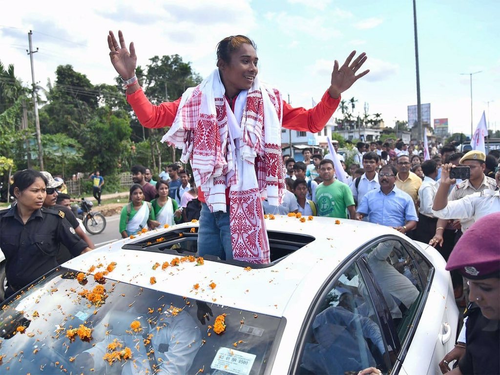 A red carpet welcome by Assam Govt and paraded in an open vehicle where Kids, Children, Teenagers, Adults & Elderly people followed her.

Hima Das will go down as one of the finest Atheletes India will ever have, she still too young. Her best years yet to arrive. 
#DhingExpress