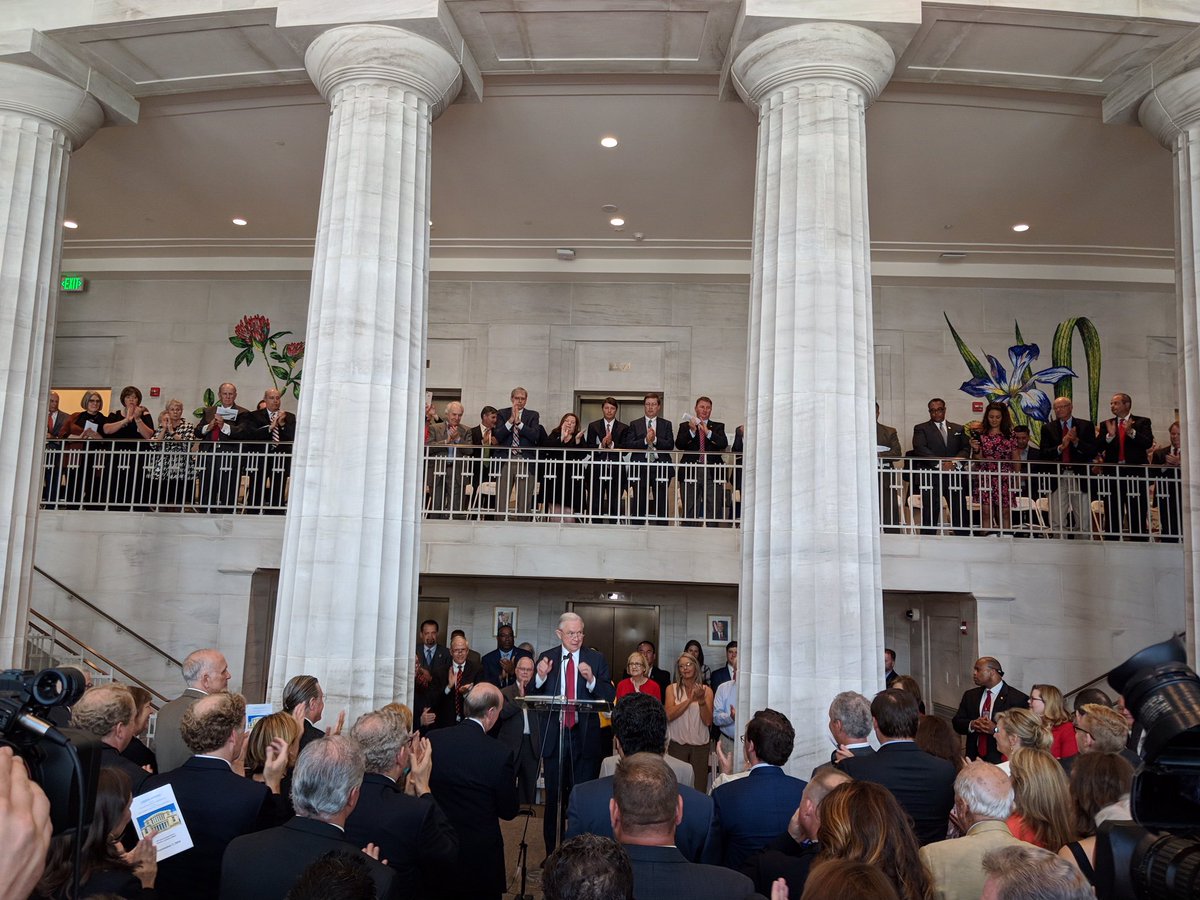 Attorney General Sessions speaks at a podium in crowded courthouse