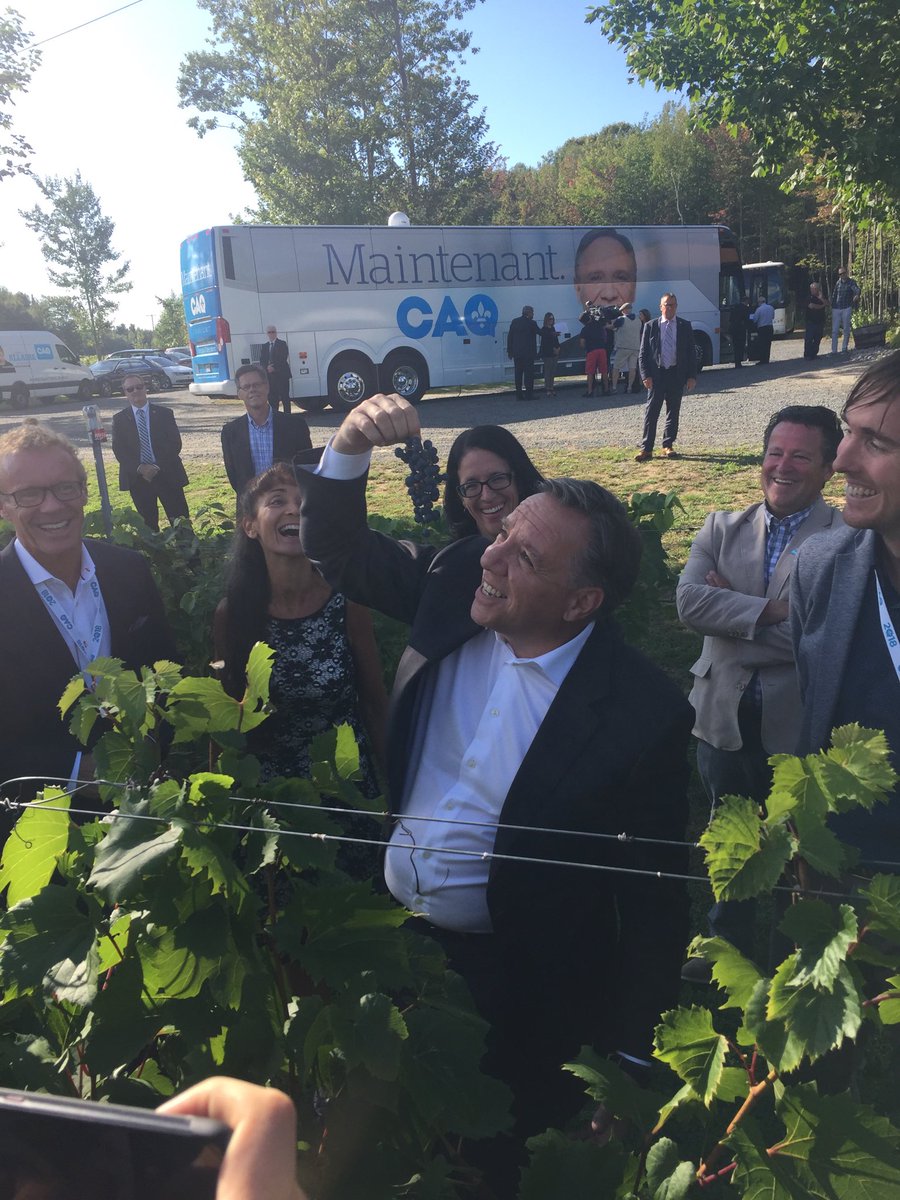 ⁦francoislegault⁩ hams it up with a bunch of grapes at Vignoble Prémont